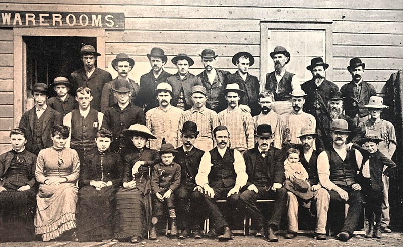 Employees of the Northwestern Casket Company posed outside the factory, 1886