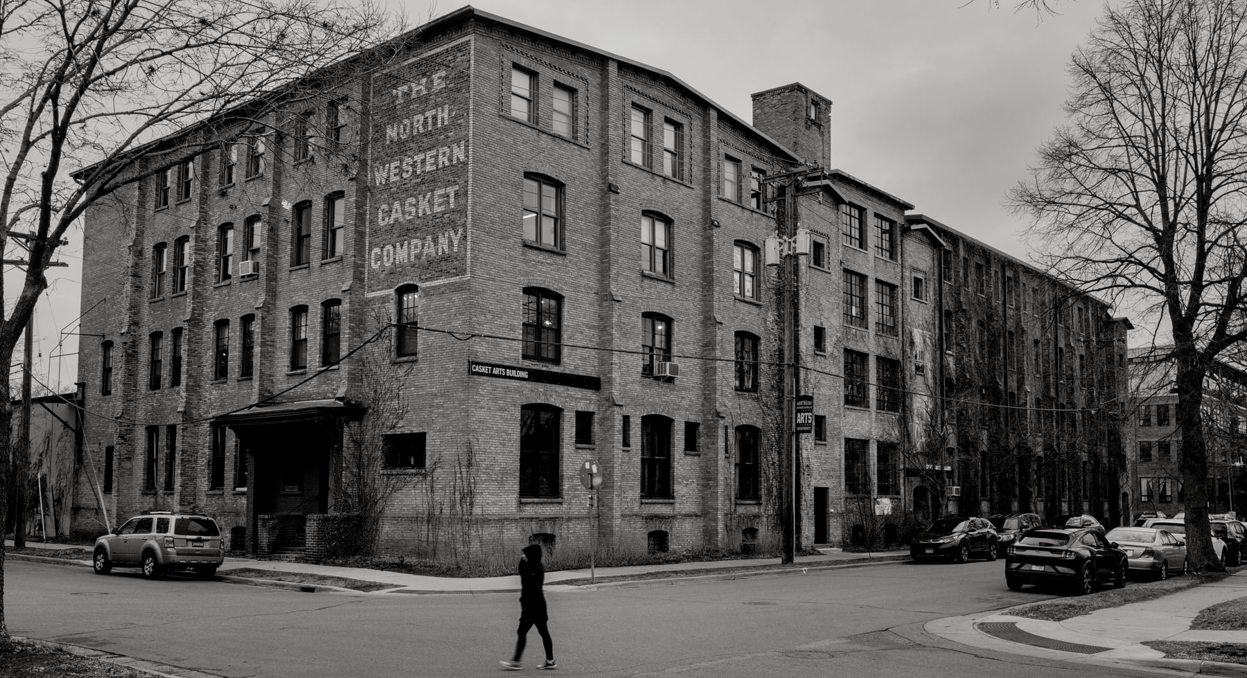 The Casket Arts building at 681 17th Ave NE, its painted Northwestern Casket Company ghost sign above the corner entrance